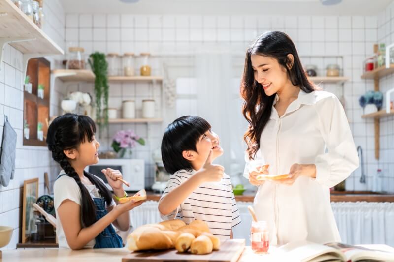 family playing, making food in kitchen at home