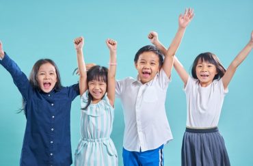 children happy and enjoying time together while cheering on