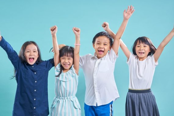 children happy and enjoying time together while cheering on