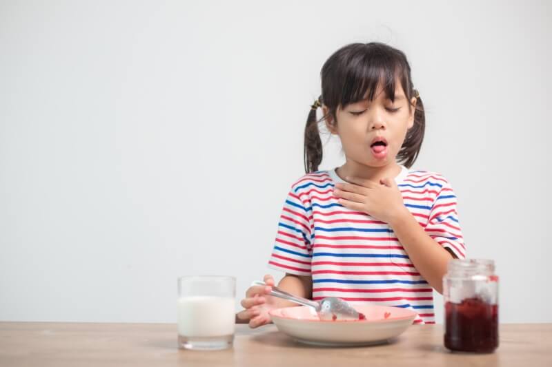 girl clearing throat from stuck food