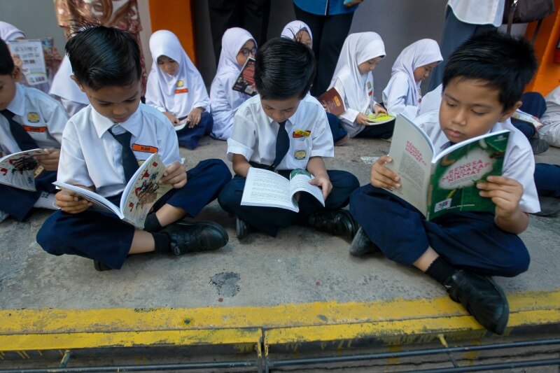 school children reading books