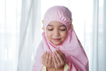 young child in pink prayer garment