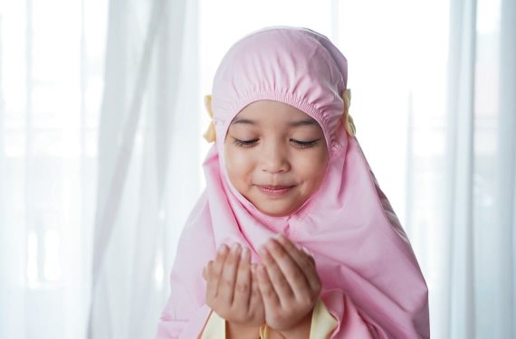 young child in pink prayer garment