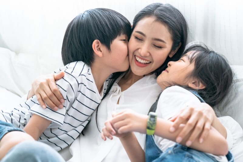 Asian mom playing with her son and daughter