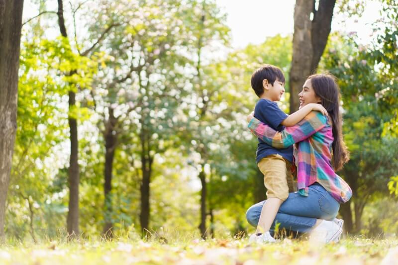 son and mother in park 