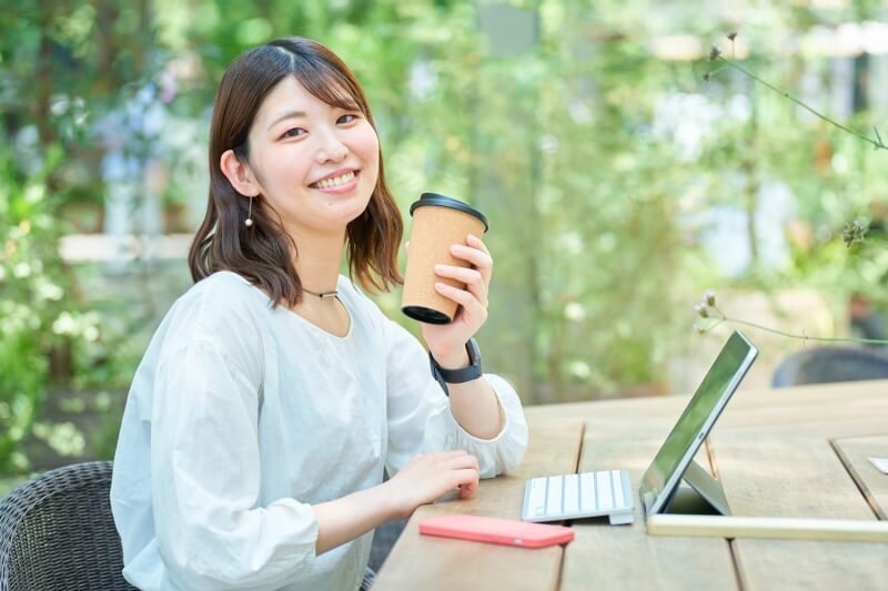 woman enjoying coffee outdoors 