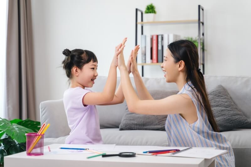 mother and daughter high five celebrate achievement