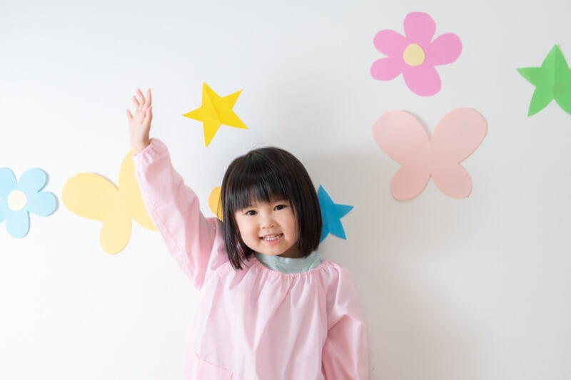 young girl putting hand up feeling happy