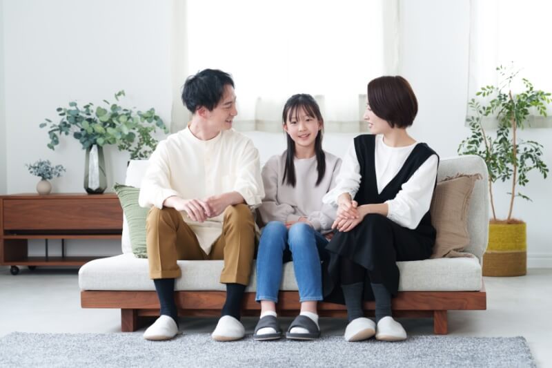 asian family relaxing in the living room