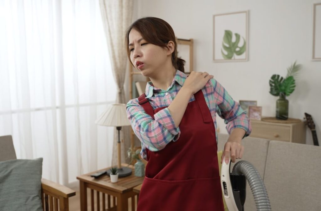 woman feeling back pain after cleaning house tired housewife mum