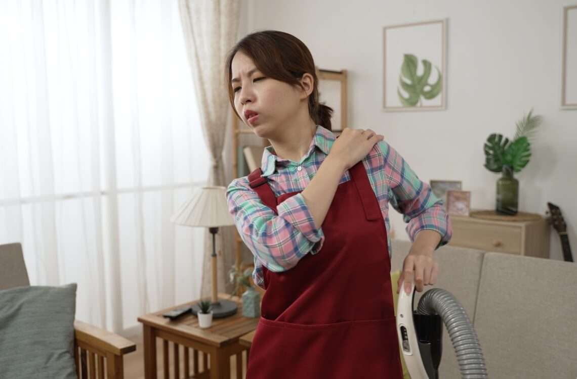 woman feeling back pain after cleaning house tired housewife mum
