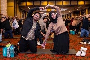 parents showing heart shape attending workshop antenatal class