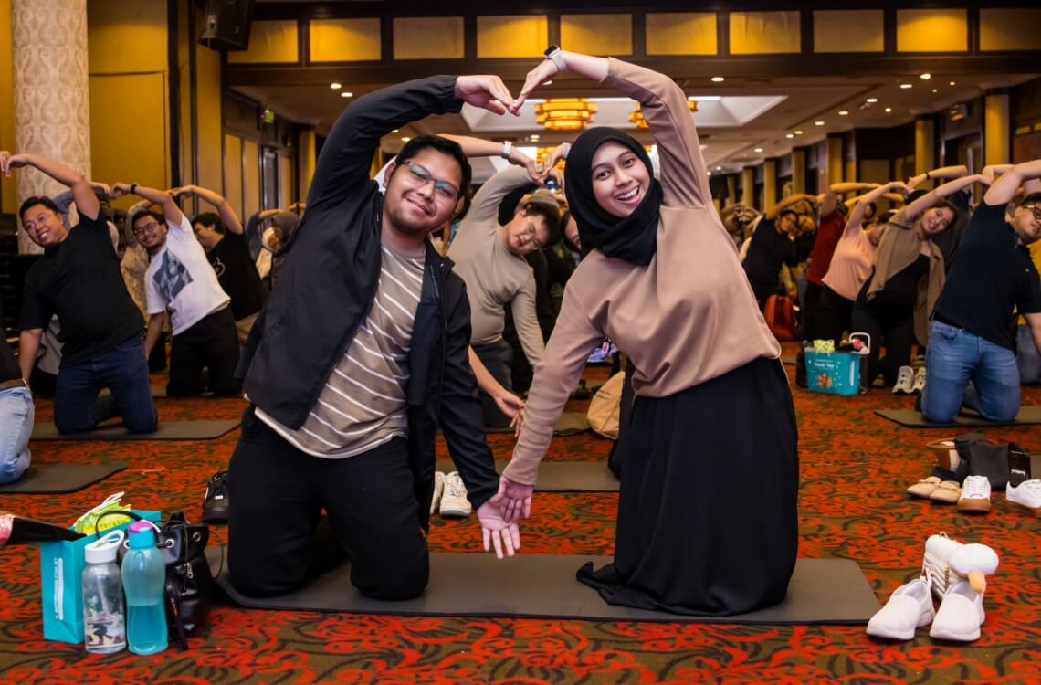 parents showing heart shape attending workshop antenatal class