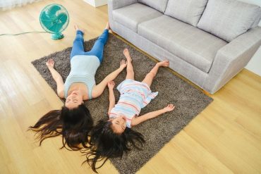 mother and daughter relaxing from the heat on the floor