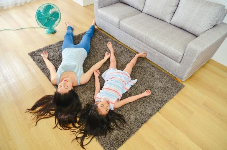 mother and daughter relaxing from the heat on the floor