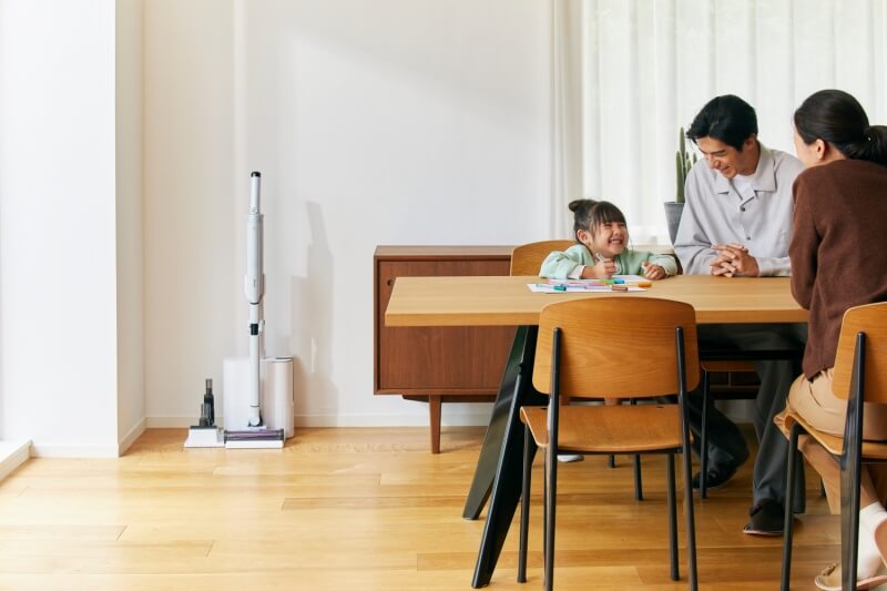 family sitting by dining table with vacuum at the dock 