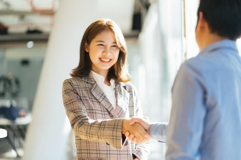 women in suit dealing business
