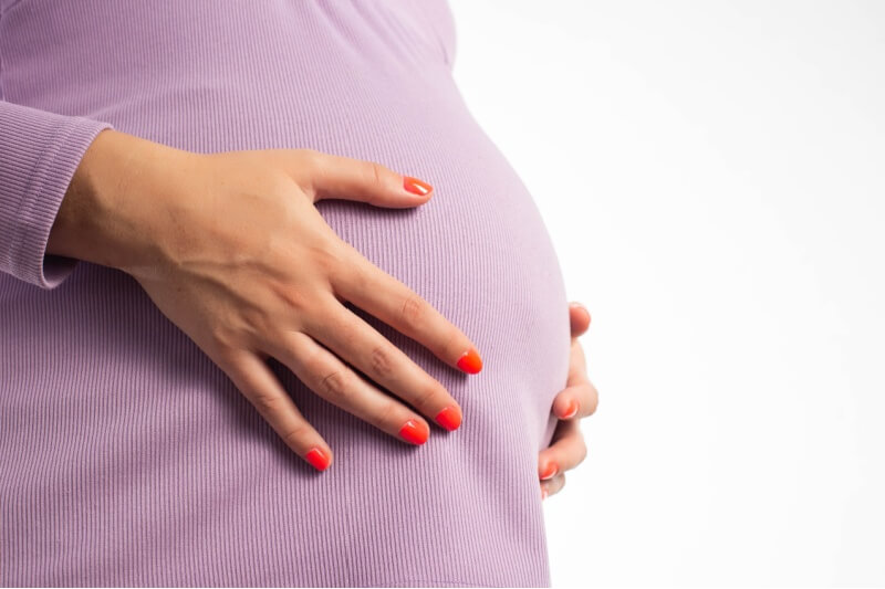 image of woman holding pregnancy belly