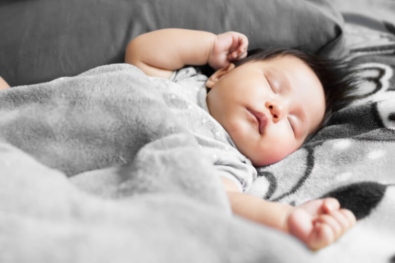 newborn baby sleeping with blanket