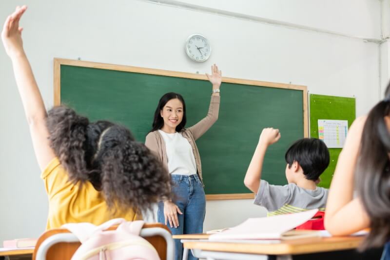young teacher educating children in class