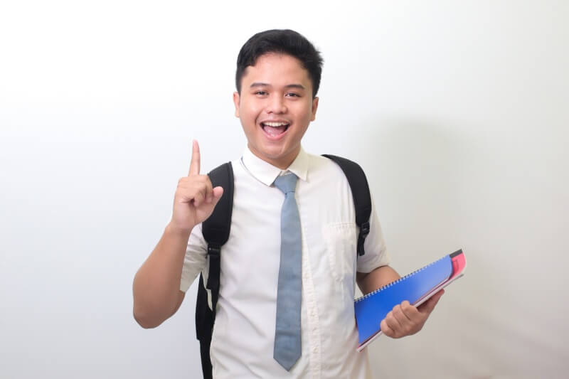 teenager with school bag and in school uniform