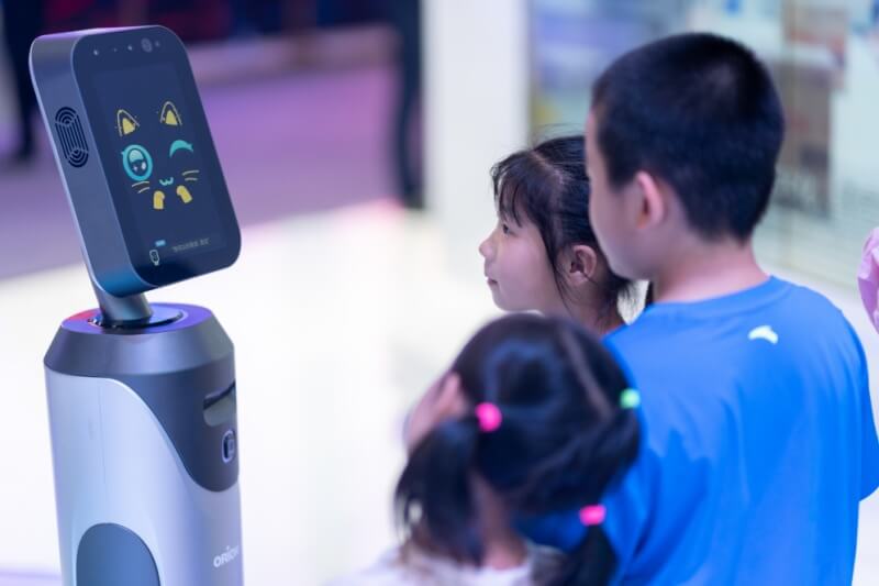 young children looking at server cat robot ai technology