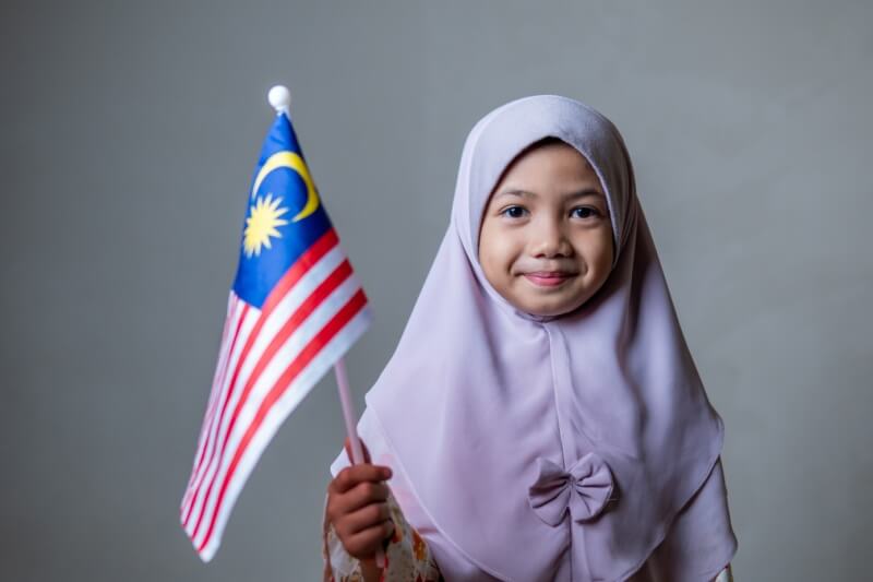 young girl holding malaysian flag