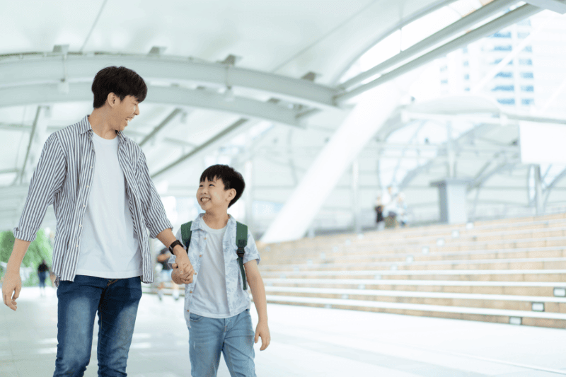 boy and father walking together and enjoying quality time