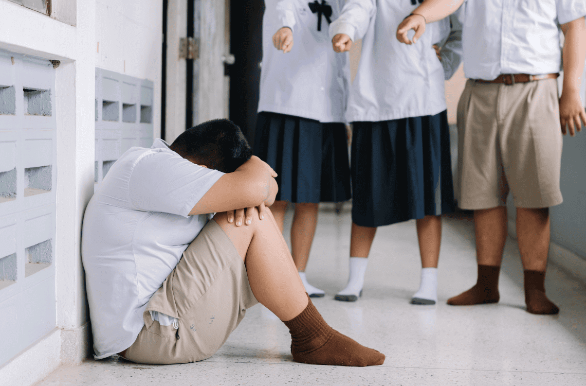 student bullying victim by classmates crying sadly being bullied