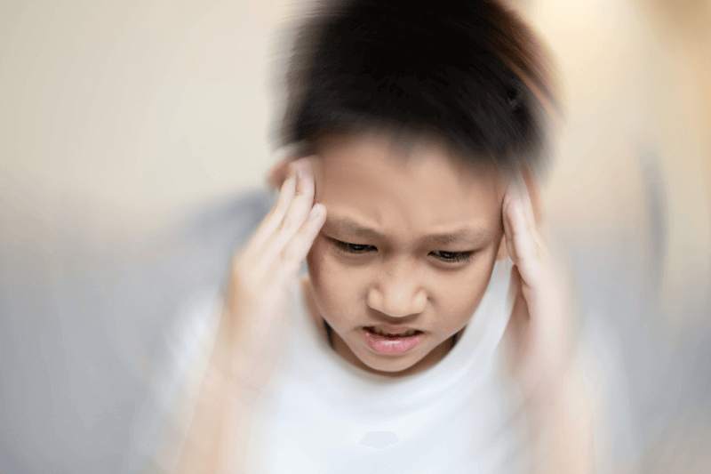 Asian child boy with dizziness,nausea and vertigo,giddiness,sensation of whirling,loss of balance,feeling faint,dizzy attack