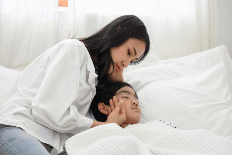 mother taking care and checking her son temperature during sick and have a high body temperature
