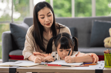 mum teaching daughter studies practicing homeschool