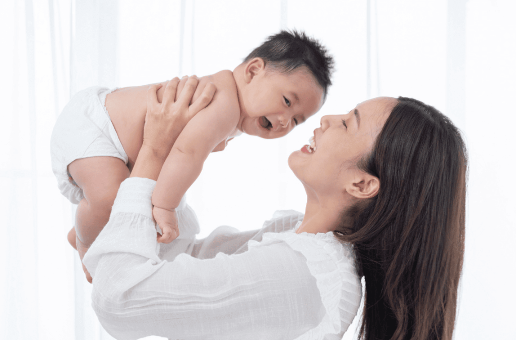 mother holding baby below 1 year old and enjoying quality time together