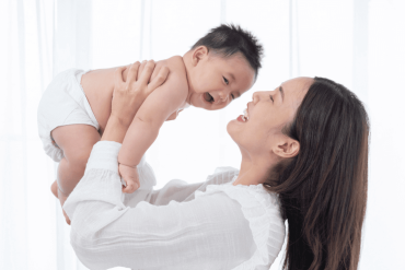 mother holding baby below 1 year old and enjoying quality time together