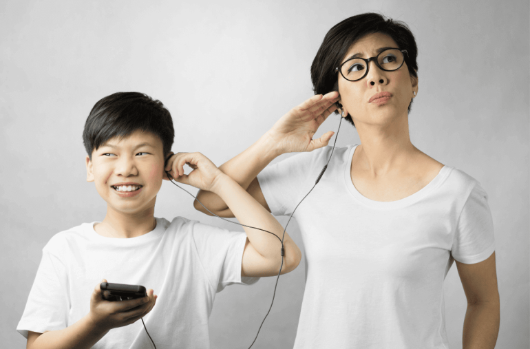preteen boy and mom listen to music together from earphones