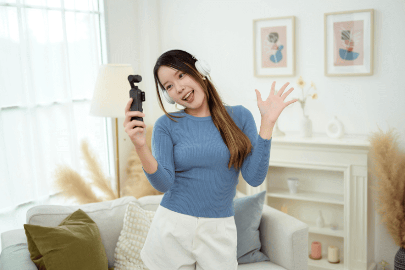 woman enjoying making video in living room at home