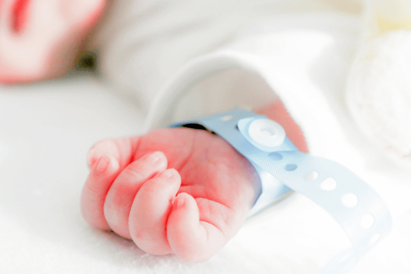 premature baby with the hospital tag