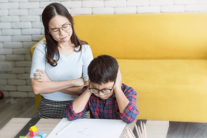 Mother is angry at her son who is doing homework