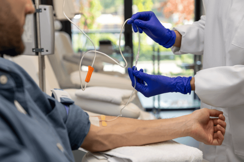Cancer Patient man receiving infusion drip in hospital