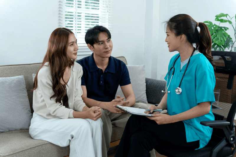 healthcare professional provides private medical consultation to young adult couple
