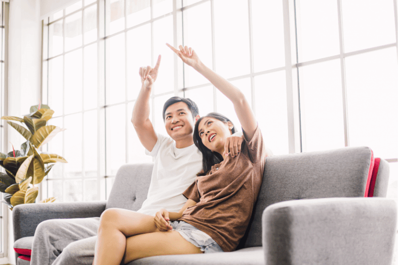 couple in love thinking about something on sofa at home