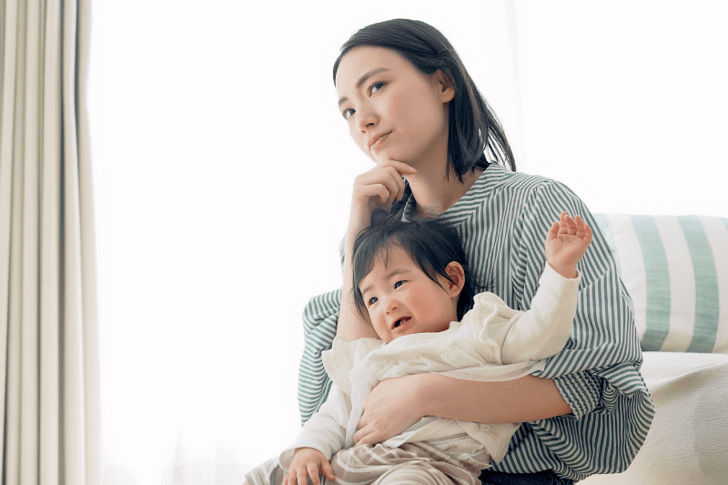 young asian mother and baby looking worried