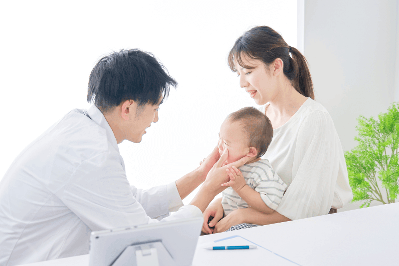 doctor examining a baby