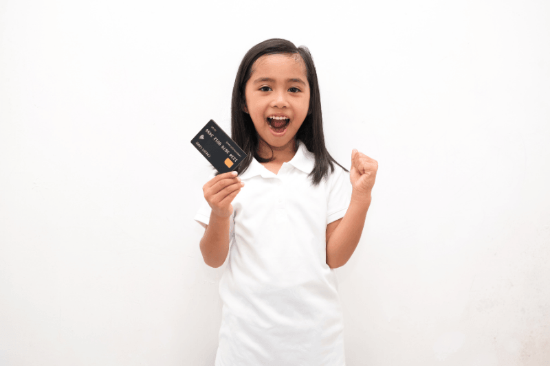 girl holding credit card isolated white background