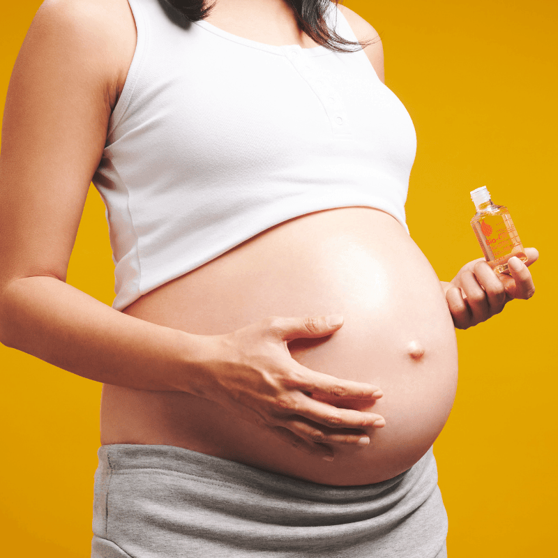 pregnant woman using natural oil for skincare option