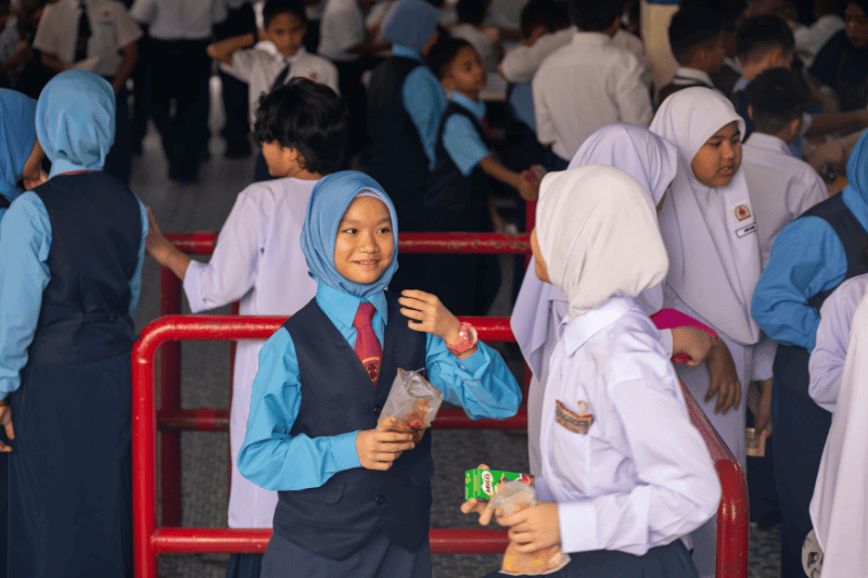 Students at Sekolah Kebangsaan Kelana Jaya 1 arrive for their first day of school, filling the campus with excitement and nervous anticipation.