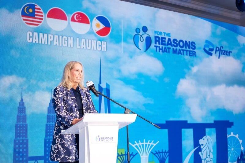 woman giving speech on podium for pfizer