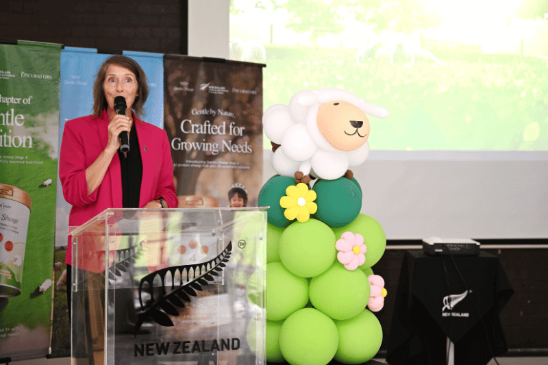 woman giving speech on podium for product launch