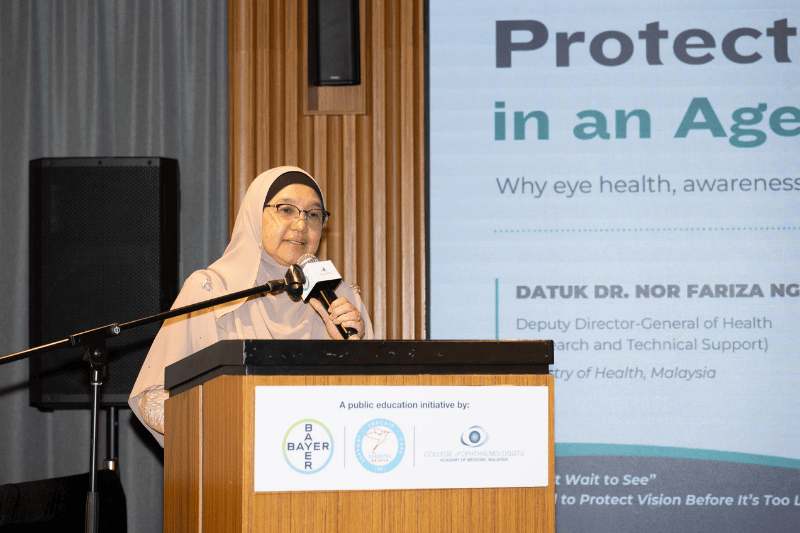 medical doctor speaking on stage with mic in hand
