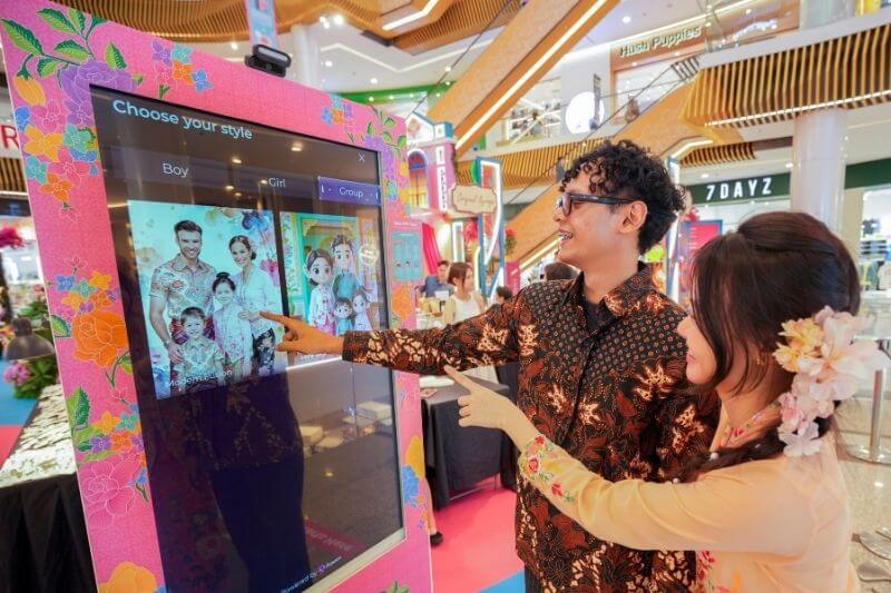 a man and woman wearing peranakan traditional clothes at a photo booth choosing photo styles